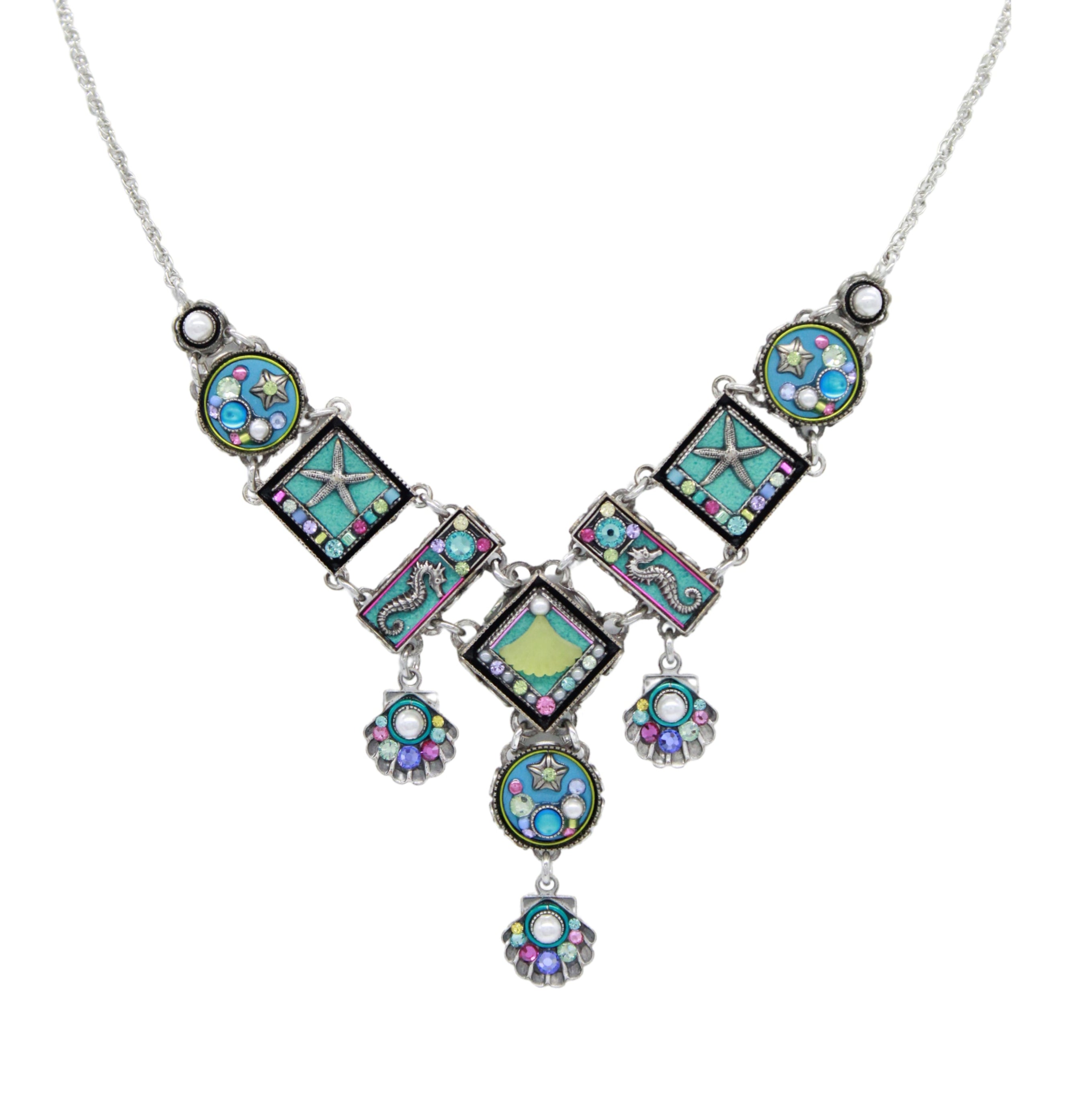 The Ocean Elaborate Soft Necklace by Firefly is a handmade silver piece from Guatemala, featuring colorful square and round pendants with star, heart, and swirl designs plus three gemstone dangles for a whimsical geometric accent.