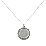 The Firefly Beach Glass Round Soft Necklace features a delicate silver chain and a textured round pendant, showcased on a plain white background.