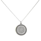 The Firefly Beach Glass Round Soft Necklace features a delicate silver chain and a textured round pendant, showcased on a plain white background.