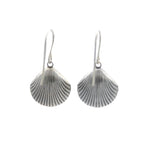 The Playa Shell Large Soft Earrings by Firefly feature handmade silver scallop shell shapes with ridged details and simple hooks. These hypo-allergenic earrings from Firefly are shown against a plain white background.
