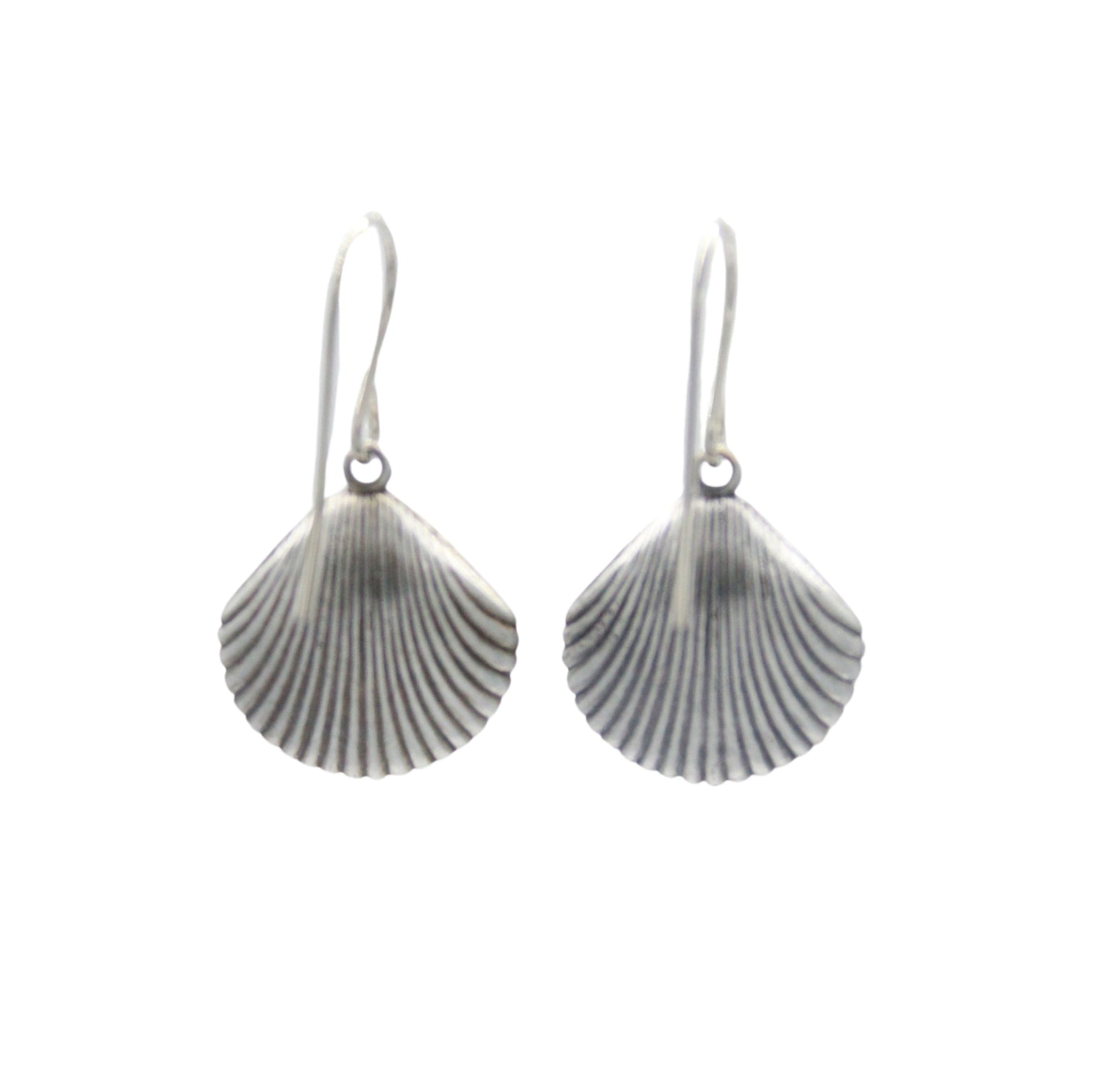 The Playa Shell Large Soft Earrings by Firefly feature handmade silver scallop shell shapes with ridged details and simple hooks. These hypo-allergenic earrings from Firefly are shown against a plain white background.