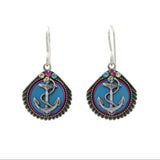 The Playa Anchor Soft Earrings by Firefly feature seashell and anchor designs with decorative accents on a blue background. Handmade in Guatemala, these fair-trade earrings from Firefly Jewelry add coastal charm to any outfit.