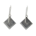 Beach Pearl Diamond Shell Soft Earrings by Firefly feature simple, flat diamond-shaped pendants on hooks. Handmade in Guatemala, these silver dangle earrings are shown on a plain white background.