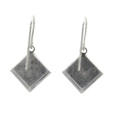 Beach Pearl Diamond Shell Soft Earrings by Firefly feature simple, flat diamond-shaped pendants on hooks. Handmade in Guatemala, these silver dangle earrings are shown on a plain white background.