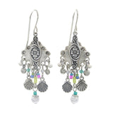 Firefly Beach Pearl Diamond Shell w/Fringe Soft Earrings feature ornate silver design, floral engravings, dangling seashell-shaped charms, colorful beads, and white pearl accents. Handmade by Firefly in Guatemala.