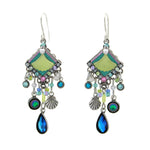 The Beach Glass Water Fall Soft Earrings by Firefly feature ornate silver-tone dangles with green fan tops, blue and purple gems, shell charms, and teardrop blue crystals—unique handmade jewelry inspired by fair-trade craftsmanship.