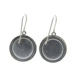 Beach Glass Round Soft Earrings by Firefly feature a silver-toned, textured border and smooth center. These fair-trade dangle earrings are displayed on a white background.