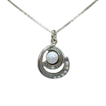 The Mediterranean Artists Co. Sterling Silver Spiral Freshwater Pearl Center Necklace features a circular sterling silver pendant with a large central freshwater pearl and smaller pearls set in a crescent design.