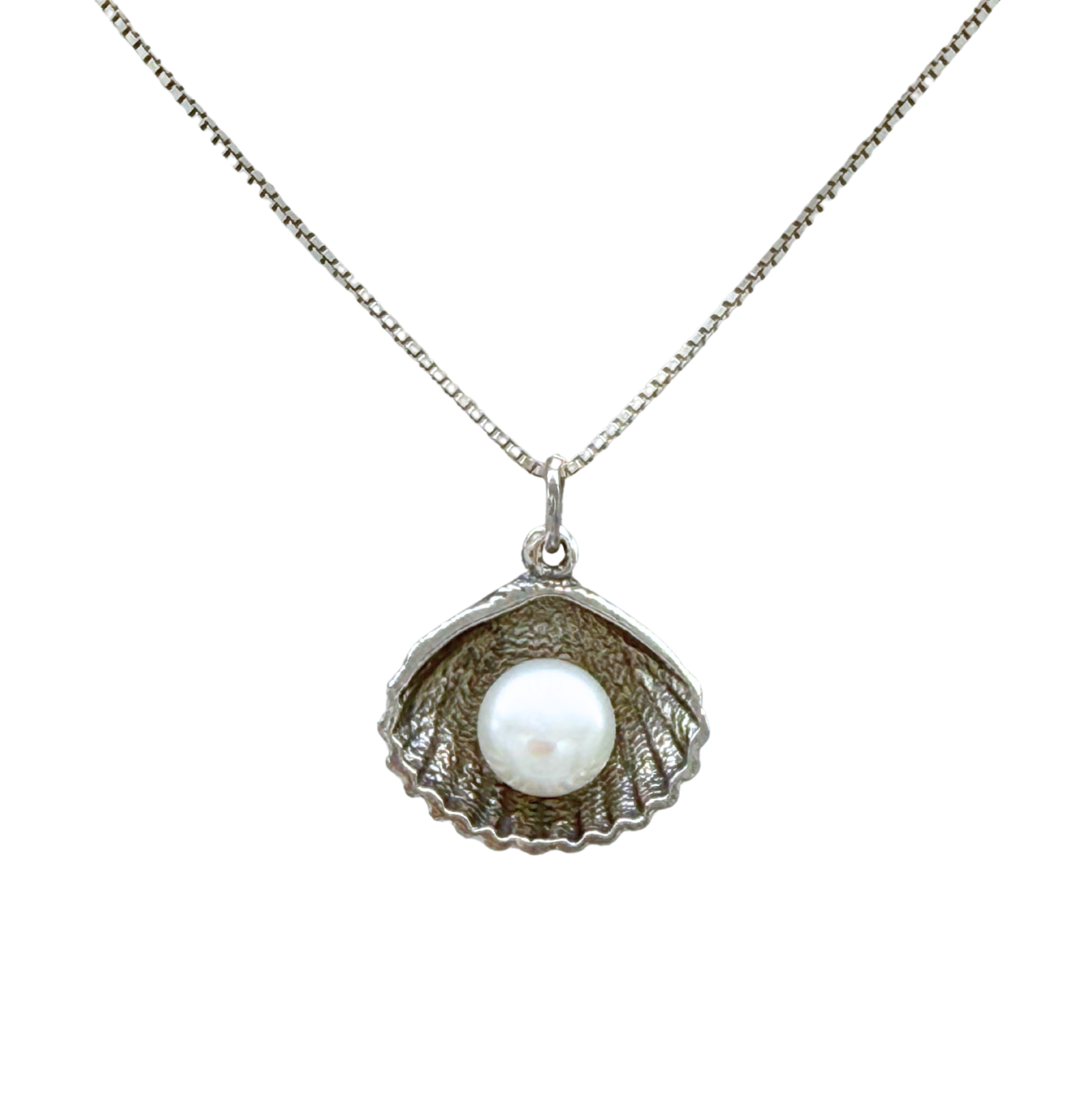 The Sterling Silver Freshwater Pearl in Shell Necklace by Mediterranean Artists Co. Sterling Silver features a delicate box chain and an open seashell pendant with a single white freshwater pearl, perfect for lovers of elegant jewelry.
