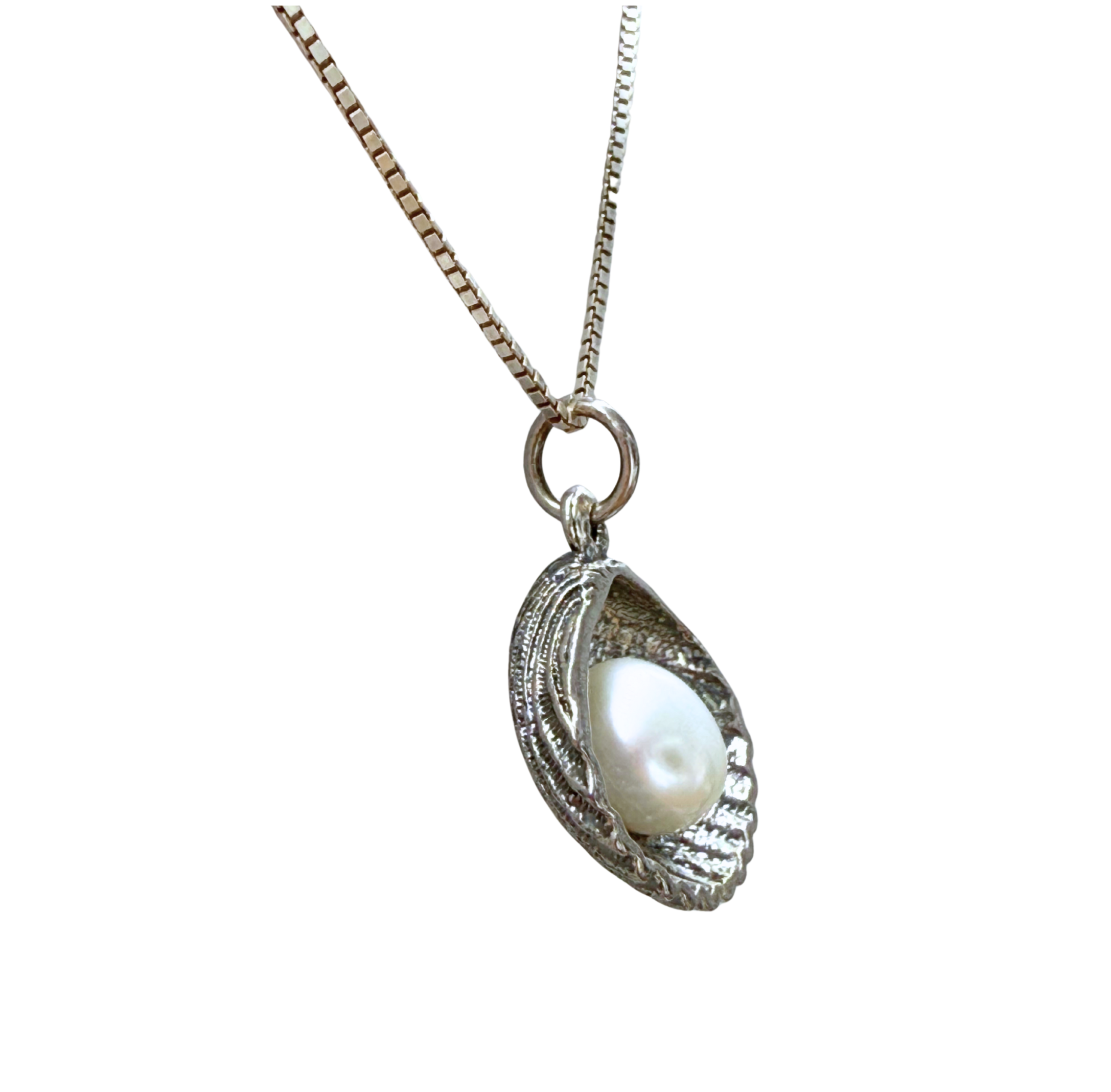 The Sterling Silver Freshwater Pearl in Shell Necklace by Mediterranean Artists Co. Sterling Silver features a seashell-shaped pendant with a white pearl, shown on a white background. Shop this elegant piece from our blowout sale!.