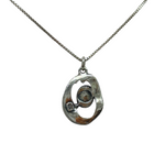 The Mediterranean Artists Co. Sterling Silver Oval Freshwater Pearl in Center Necklace features a 925 sterling silver pendant with an abstract oval charm and pearl accent—now available at our blowout sale.