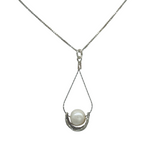 The Sterling Silver Wire Basket Freshwater Necklace by Mediterranean Artists Co. Sterling Silver features a white freshwater pearl in a teardrop wire setting—a perfect choice for freshwater pearl necklace enthusiasts.