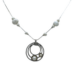 The Sterling Silver Circles Freshwater Pearl Station Chain Necklace by Mediterranean Artists Co. Sterling Silver features three interlocking circles, each with a pearl, and pearls spaced along the chain. Shown on a white background.