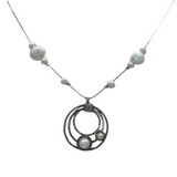 The Sterling Silver Circles Freshwater Pearl Station Chain Necklace by Mediterranean Artists Co. Sterling Silver features three interlocking circles, each with a pearl, and pearls spaced along the chain. Shown on a white background.