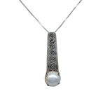 The Mediterranean Artists Co. Sterling Silver White Mabe Pearl Art Deco Necklace features an engraved swirl pendant with a round pearl on a thin chain. Shop elegant freshwater pearl necklaces in our blowout sale.