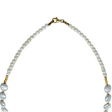 The Mediterranean Artists Co. Two Tone Gold Plated Freshwater Pearl Collar with Swirls features small white freshwater pearls, gold accents, and a gold-plated sterling silver lobster clasp, shown on a white background.