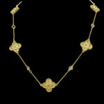 The Be-Je Designs Gold Clovers & CZ Insets Necklace features three clover-shaped pendants with cubic zirconia on a delicate, adjustable 14kt gold chain, adding elegance to any look.