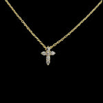 The Be-Je Designs Small Gold Pave CZ Cross Necklace features a 14kt gold adjustable chain and a shimmering cubic zirconia cross pendant, elegantly set against a solid black background.