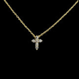 The Be-Je Designs Small Gold Pave CZ Cross Necklace features a 14kt gold adjustable chain and a shimmering cubic zirconia cross pendant, elegantly set against a solid black background.