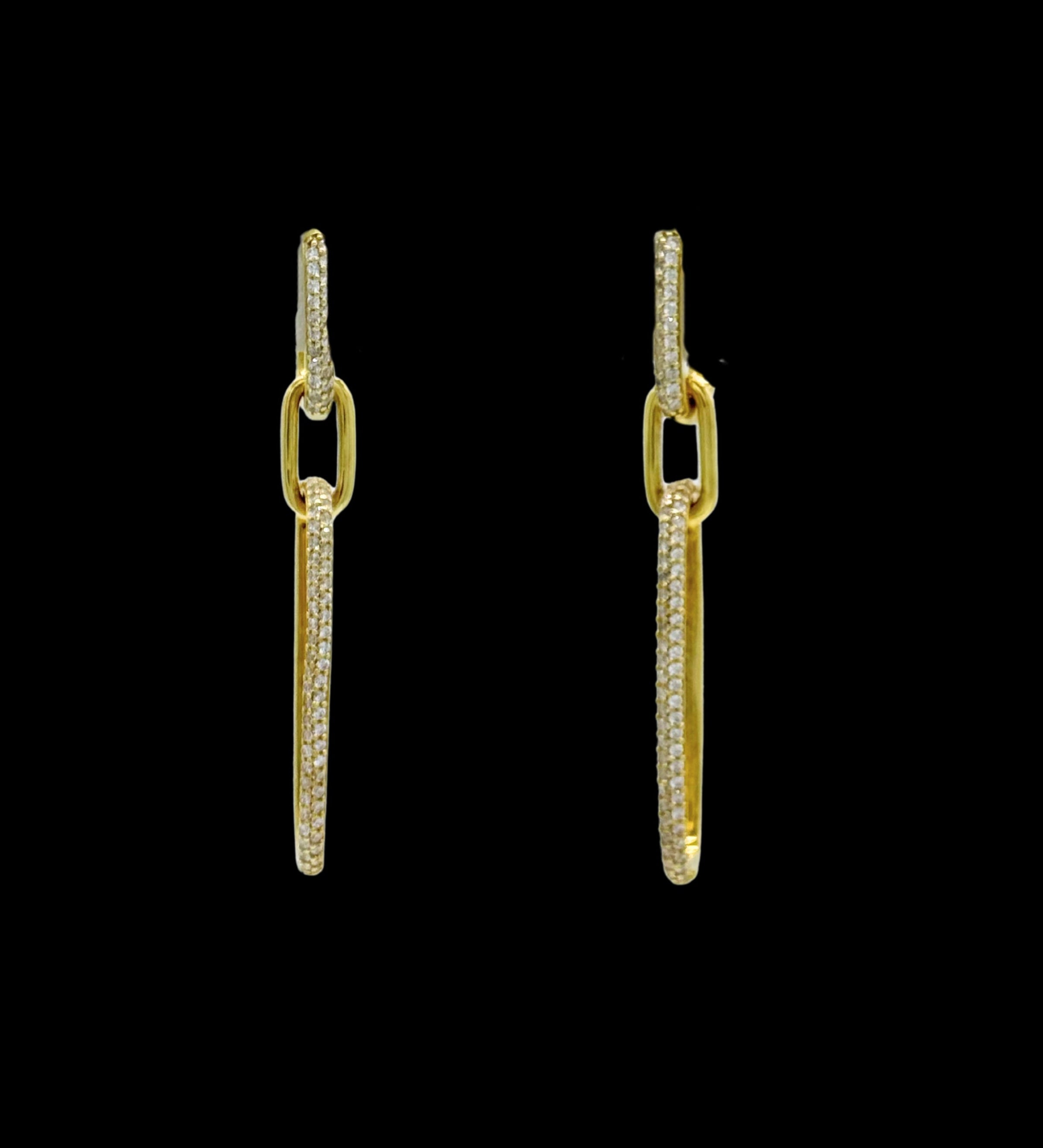 The Be-Je Designs Gold Pave CZ Double Link Earrings feature elongated 14kt gold rectangular links embellished with clear cubic zirconia, shown against a black background.