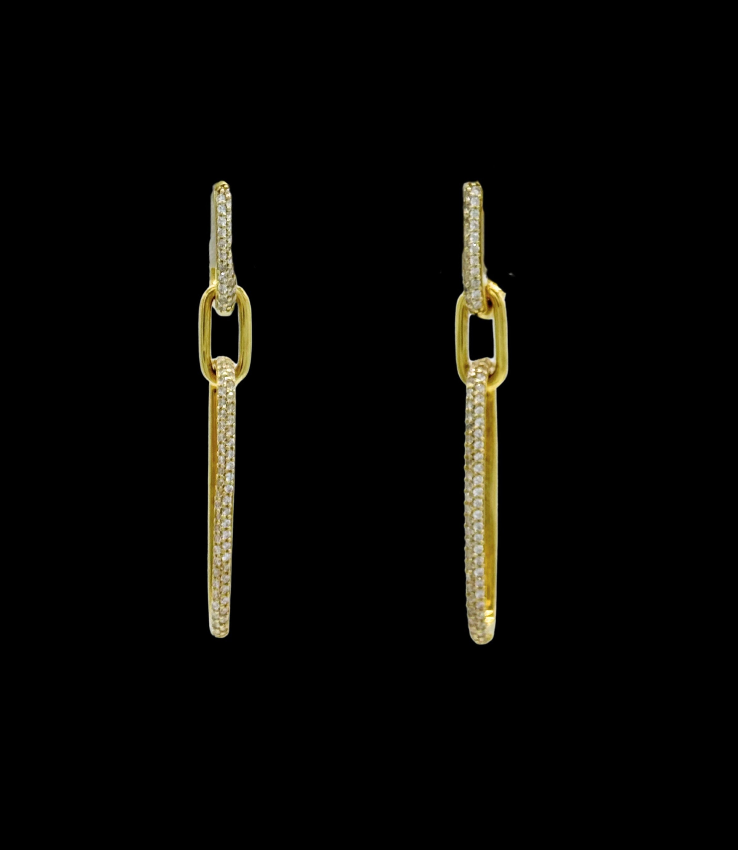 The Be-Je Designs Gold Pave CZ Double Link Earrings feature elongated 14kt gold rectangular links embellished with clear cubic zirconia, shown against a black background.