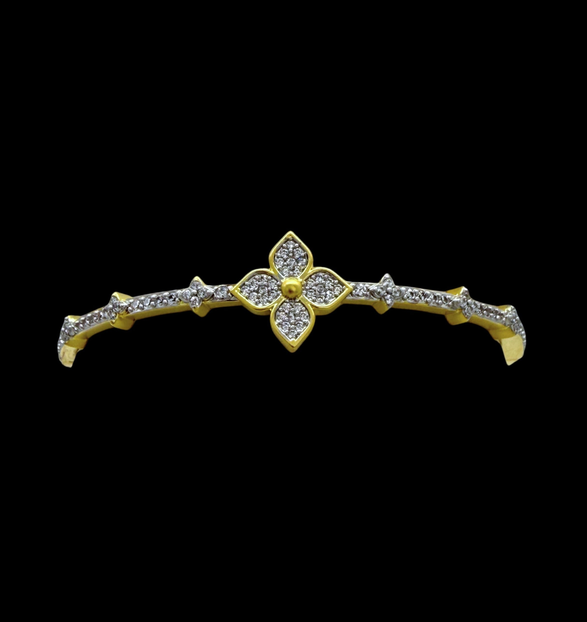 The Gold Pave Clover CZS Bracelet by Be-Je Designs features a sparkling clover motif with CZ accents for everyday luxury, shown against a black background.