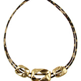 Origin Light Matte Gold Leopard Print Necklace featuring two leopard print cords and three asymmetrical matte gold charms with a magnetic closure.