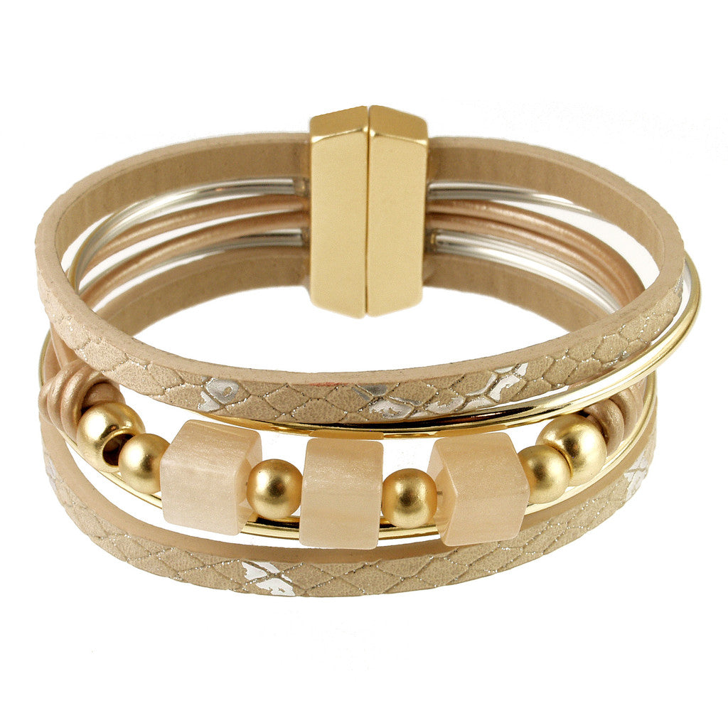 The Origin BR: Light Matte Gold/Champagne Resin bracelet features multiple beige and gold strands adorned with geometric beads, light matte gold metallic accents, champagne resin details, and is finished with a magnetic clasp. It is presented against a white background.
