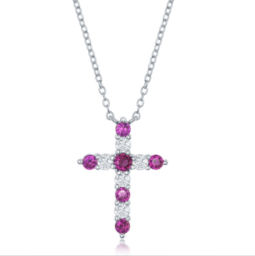 The Classic of New York Sterling Silver Birthstone Cross (July) Necklace features a cross pendant with alternating round pink and clear gemstones, making it the perfect Ruby birthstone jewelry.