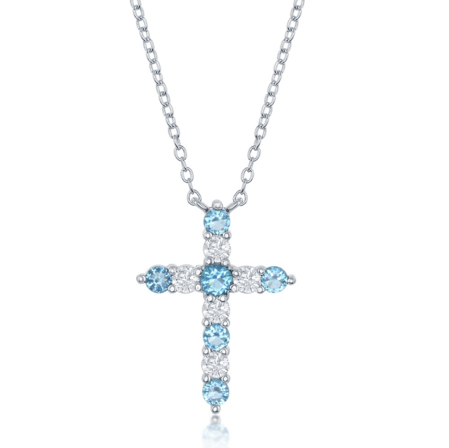 The Classic of New York NK: SS Birthstone Cross December w/chain features a sterling silver cross pendant with alternating Swiss Blue CZ and clear stones—an elegant December birthstone necklace.
