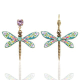 Brite Bloom Cascade Bouquet Dragonfly Crystal Dangle Earrings by Anne Koplik Designs, Inc. feature colorful enamel wings, floral accents, gold-toned bodies, and mismatched studs—a purple gem on one and a gold hook. Handmade rainbow jewelry in the USA.