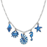 The Anne Koplik Designs Seashell Sparkling Blue Sea Life Crystal Charm Necklace features five ocean charms—seashell, crab, spiral shell, seahorse, and starfish—with sparkling blue accents for nautical flair.