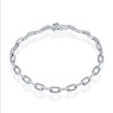 The Classic of New York Sterling Silver & CZ Paperclip Bracelet, featuring elongated oval links and sparkling stones, is showcased against a white background.