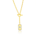 The Gold Plated North Star CZ Toggle Necklace by Classic of New York features an oblong yellow pendant bordered with clear stones, a starburst center, toggle clasp, and drop detail for stunning style.