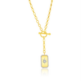 The Gold Plated North Star CZ Toggle Necklace by Classic of New York features an oblong yellow pendant bordered with clear stones, a starburst center, toggle clasp, and drop detail for stunning style.