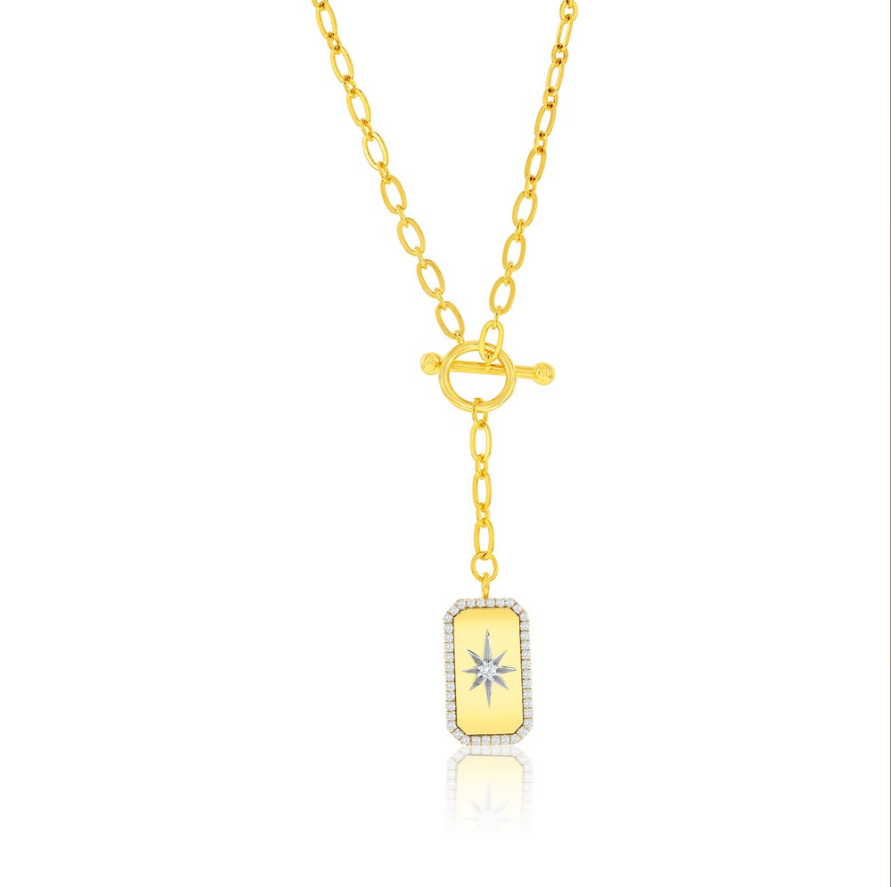The Gold Plated North Star CZ Toggle Necklace by Classic of New York features an oblong yellow pendant bordered with clear stones, a starburst center, toggle clasp, and drop detail for stunning style.