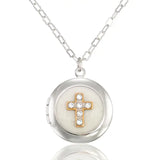 The Faithful White Shimmering Crystal Cross Locket Necklace by Anne Koplik Designs, Inc. features a cross locket with gold and rhinestone accents on a silver chain.