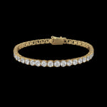 The Be-Je Designs Gold & Clear CZ Tennis Bracelet features a continuous row of oval-cut clear CZ stones set in 14kt gold, displayed on a plain black background—an elegant accessory for any occasion.