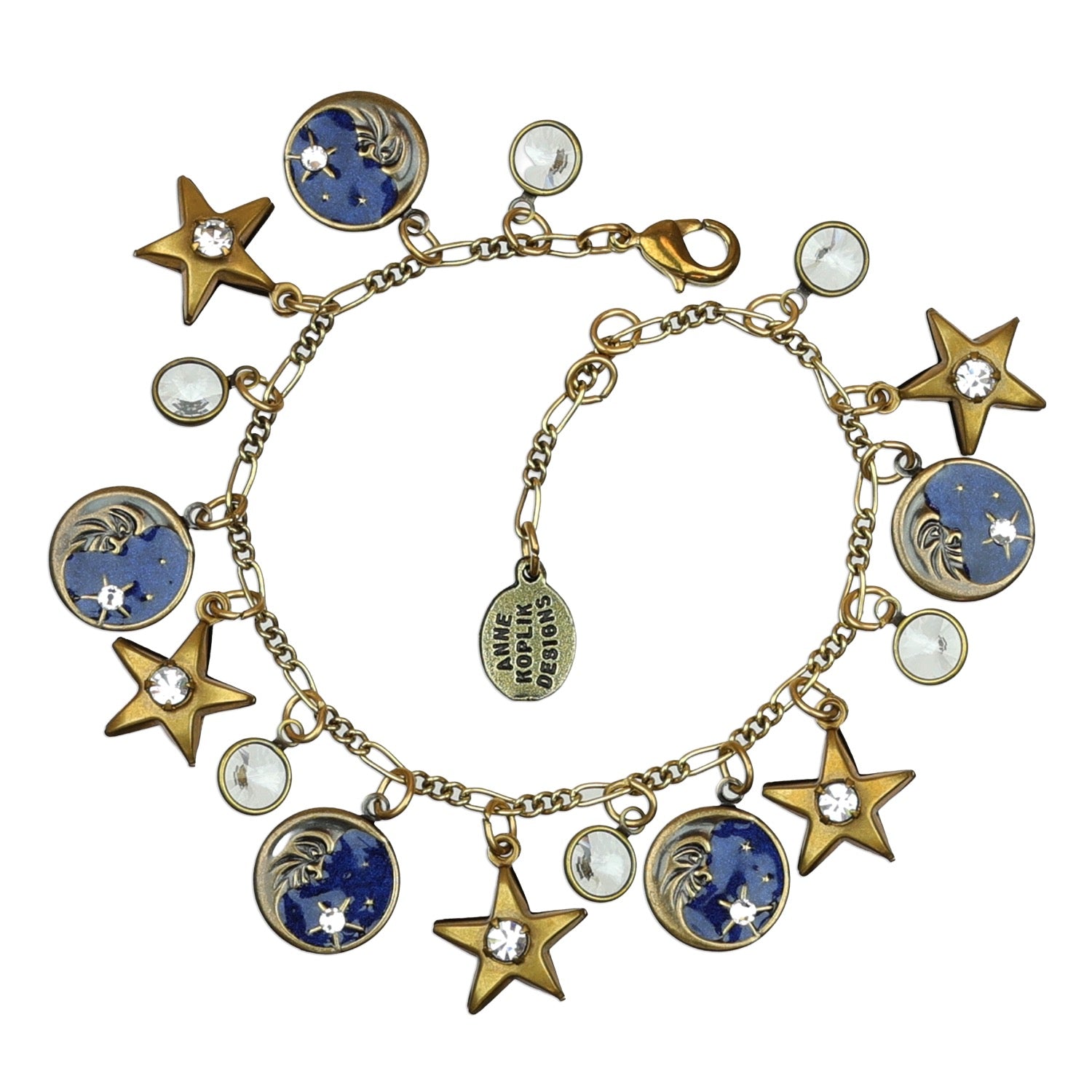 The Moon & Stars Charms Enamel & Stone Bracelet by Anne Koplik Designs, Inc. features gold star, moon, and round charms with white and blue accents—some crystal-embellished, others depicting a shimmering night sky scene.
