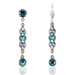The Filigree Dangle Teal Crystals w/Drop Earrings by Anne Koplik Designs, Inc. feature ornate silver plating, intricate metalwork, and multiple vertically set teal crystals with hook fastenings for an elegant look.