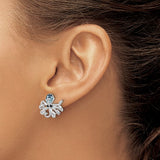 A close-up of a womans ear wearing Presco/Quality Gold Crystals Octopus Earrings, featuring detailed sterling silver tentacles and a sparkling blue crystal head.