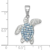 The Presco/Quality Gold Crystal Blue/Clear Turtle Pendant features clear and light blue gemstones on its sterling silver shell, displayed against an inch grid for scale—a distinctive crystal jewelry piece.