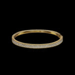 The Be-Je Designs Gold Pave Hinge Bangle Bracelet features three rows of sparkling diamonds in 14kt gold, offering everyday luxury and understated glamour, beautifully presented against a striking black background.