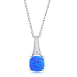 The Classic of New York Caribbean Opal Square Prong Set Necklace features a vibrant blue opal pendant in a rounded square shape, accented with a clear stone—ideal for fans of Caribbean opal necklaces. Includes chain.