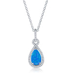 The Classic of New York Caribbean Opal 4 Prong Teardrop & CZ Border Necklace features a blue opal teardrop pendant with cubic zirconia accents on a delicate chain—a striking piece among Caribbean opal necklaces.