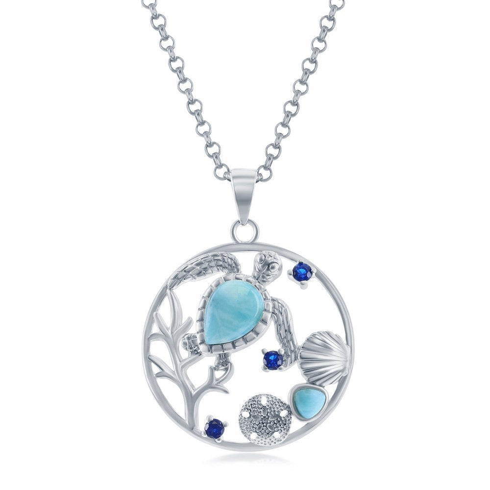 The Classic of New York Larimar Turtle, Seashell, Sand Dollar Necklace features a circular sterling silver pendant with a turtle set in blue stones and ocean-inspired accents, including a shell and sand dollar design.