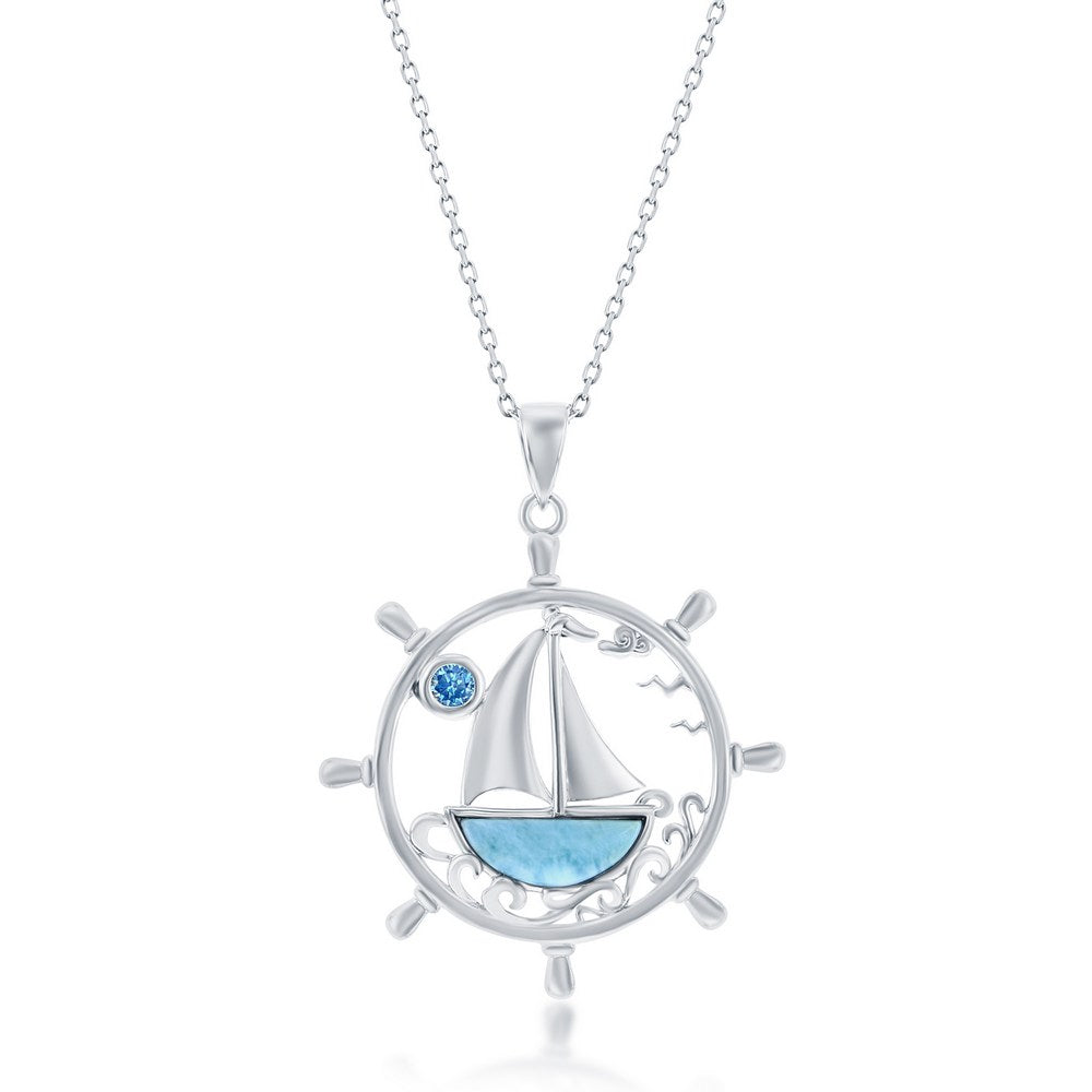 Classic of New York Larimar Inset Sailboat Inside Ship's Wheel Necklace features a sailboat on blue water, a ship’s wheel pendant, a small blue gem sun, and two flying birds. Includes chain.