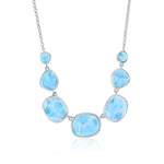The Classic of New York Larimar Irregular Shapes Necklace is crafted in sterling silver with five polished blue larimar stones featuring white marbling, symmetrically arranged and linked by a delicate chain.