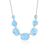 The Classic of New York Larimar Irregular Shapes Necklace is crafted in sterling silver with five polished blue larimar stones featuring white marbling, symmetrically arranged and linked by a delicate chain.