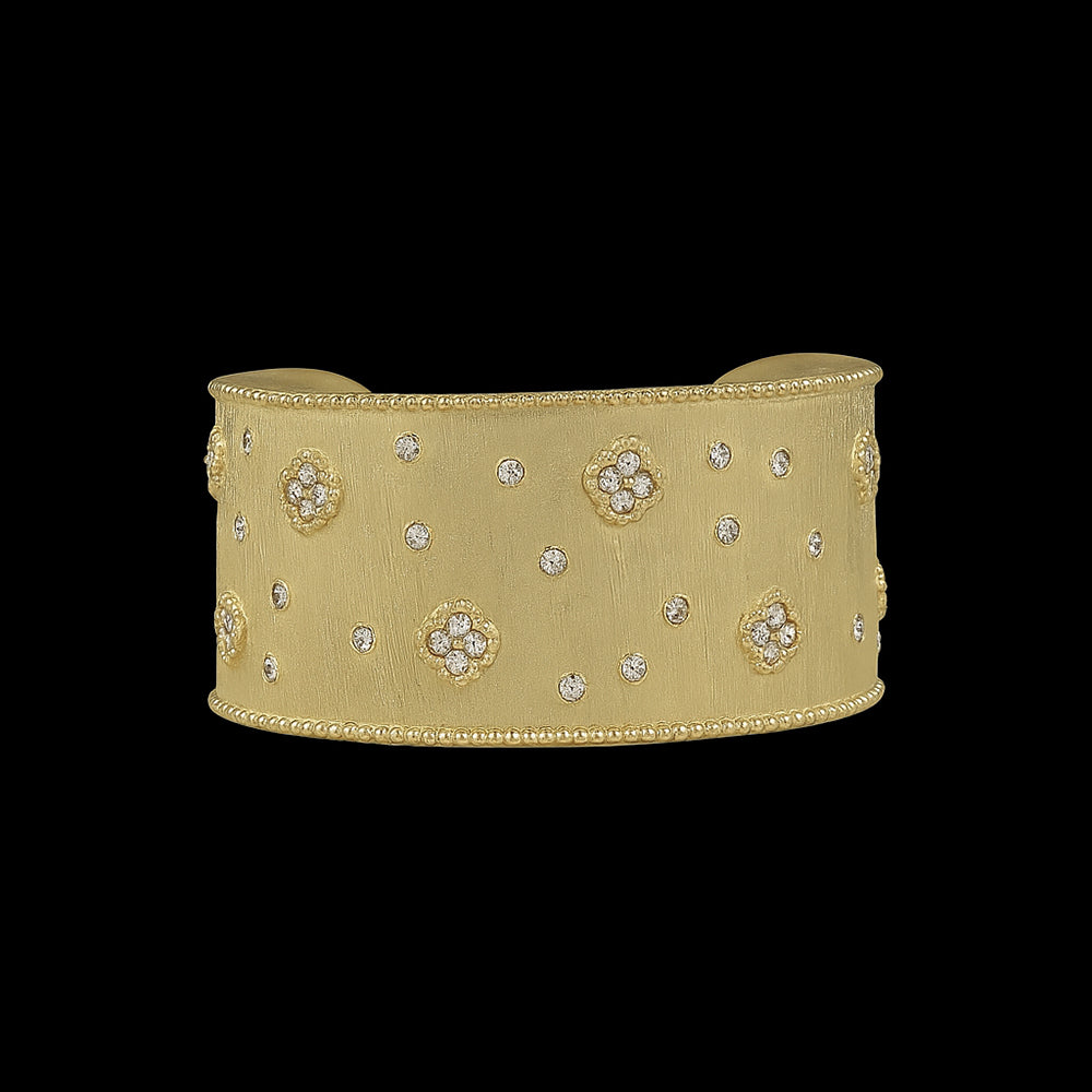 The Be-Je Designs Gold w/Tiny Pave Flowers & CZS Cuff Bracelet features a matte gold finish with scattered CZ stones and pave floral clusters—an elegant, everyday luxury accessory.